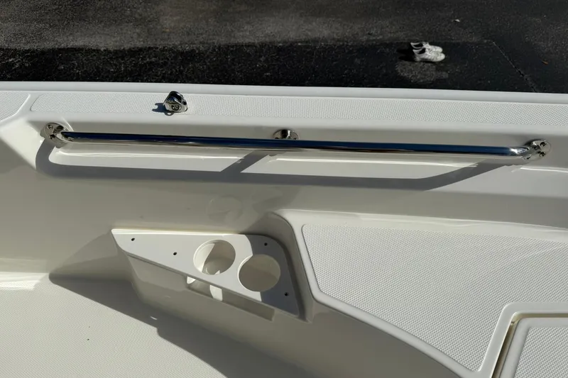 Slide: The Image of 2025 Boston Whaler 170 Montauk boat interior with stainless steel rail and cup holders. - 57
