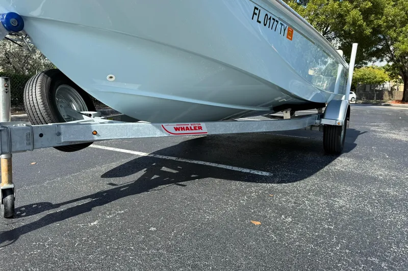 Slide: The Image of 2025 Boston Whaler 170 Montauk boat on trailer in parking lot. - 58