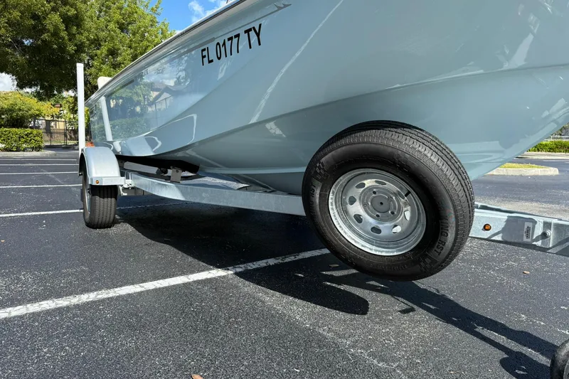 Slide: The Image of 2025 Boston Whaler 170 Montauk boat on trailer in parking lot. - 59