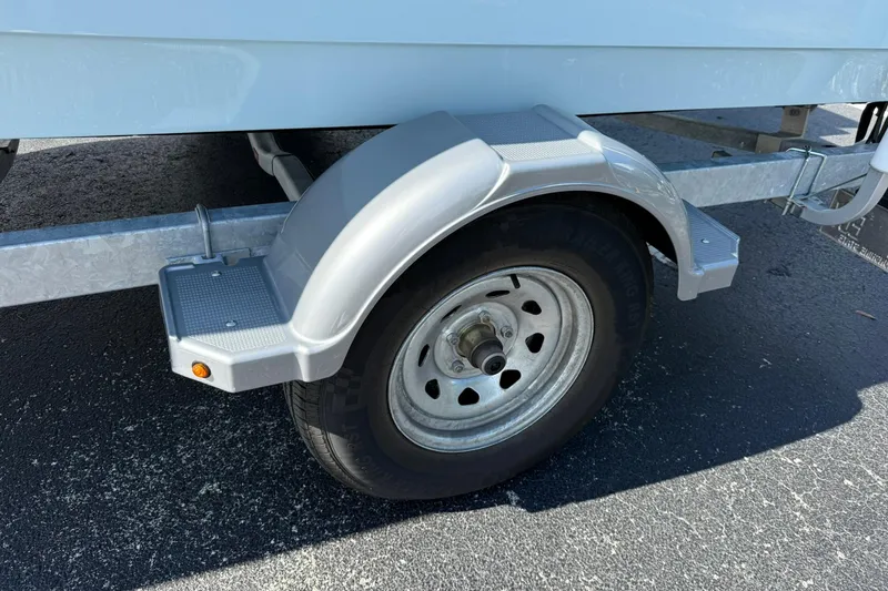 Slide: The Image of Trailer wheel of 2025 Boston Whaler 170 Montauk on asphalt surface. - 60