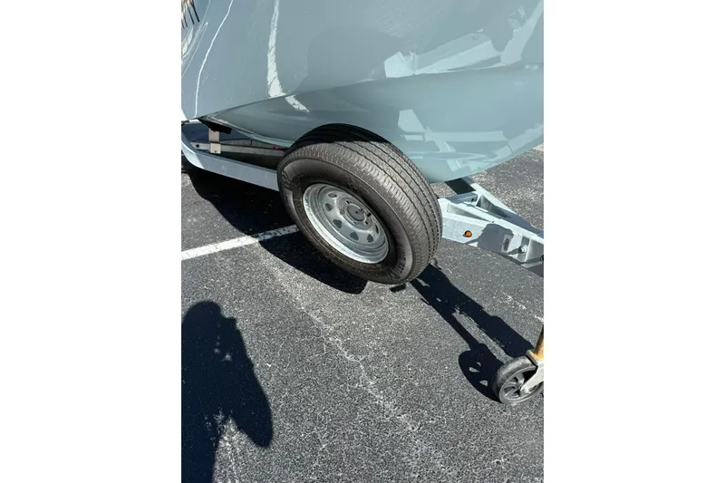 Slide: The Image of Trailer wheel of 2025 Boston Whaler 170 Montauk boat on asphalt surface. - 61