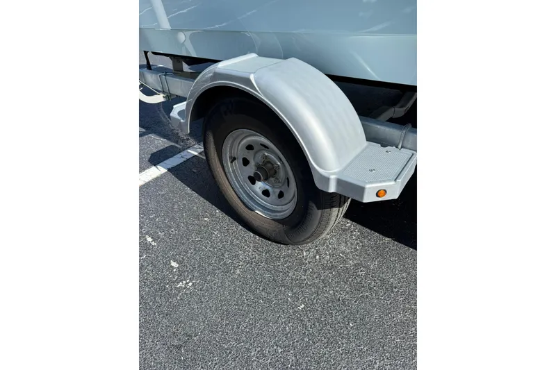 Slide: The Image of Trailer wheel of 2025 Boston Whaler 170 Montauk in parking lot. - 62