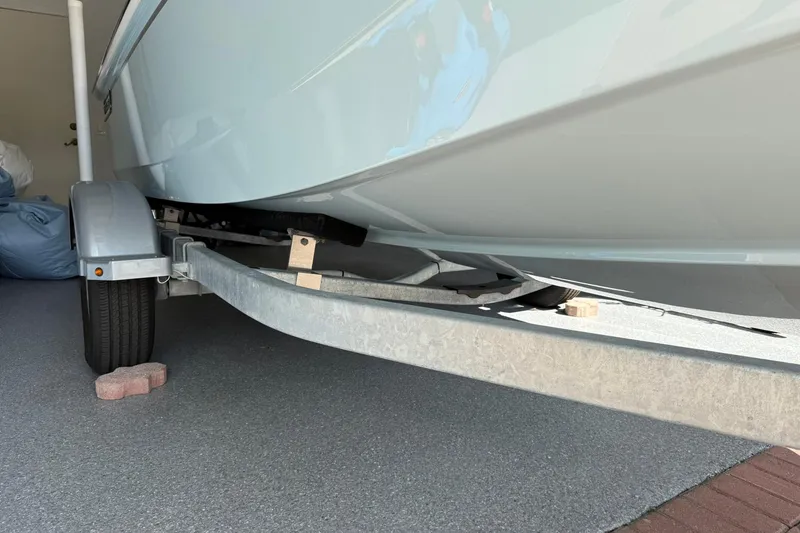 Slide: The Image of 2025 Boston Whaler 170 Montauk on trailer, garage setting, side view. - 63