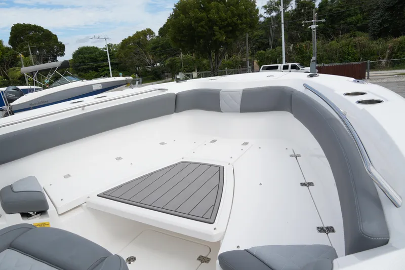 Slide: The Image of 2025 NauticStar 222 Offshore boat interior with gray seating and spacious deck. - 10