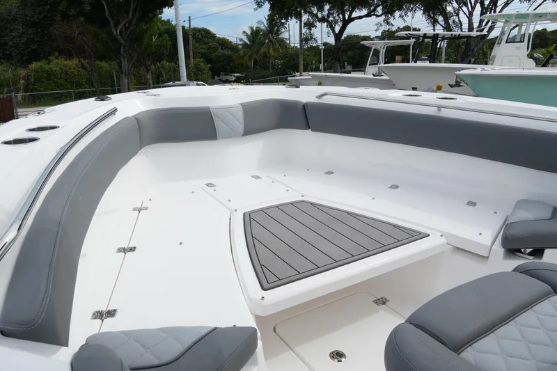 Slide: The Image of 2025 NauticStar 222 Offshore boat interior with gray seating and deck. - 11