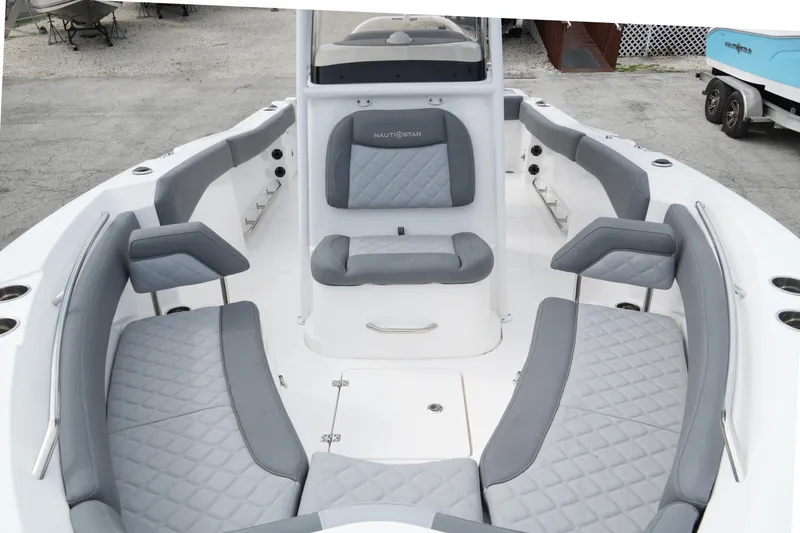 Slide: The Image of 2025 NauticStar 222 Offshore boat interior with gray cushioned seating and modern design. - 12
