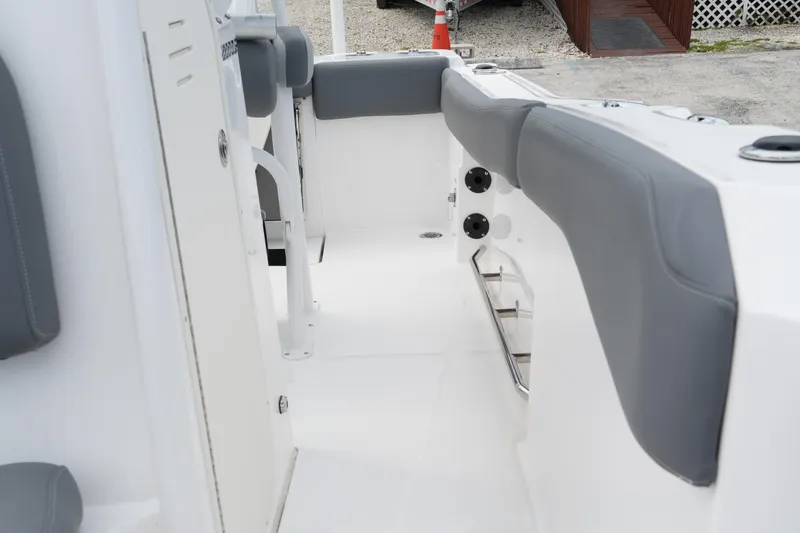 Slide: The Image of 2025 NauticStar 222 Offshore boat interior with gray seating and white deck. - 15