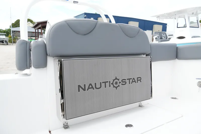 Slide: The Image of 2025 NauticStar 222 Offshore boat interior with gray seating and branded panel. - 18