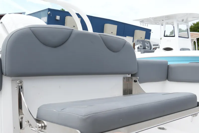 Slide: The Image of 2025 NauticStar 222 Offshore boat with gray cushioned seating and sleek design. - 19