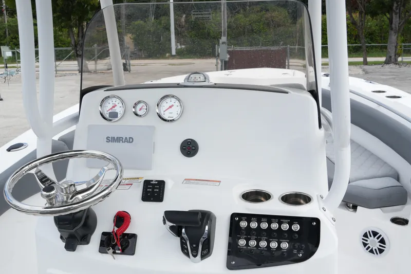 Slide: The Image of 2025 NauticStar 222 Offshore boat dashboard with steering wheel and controls. - 20