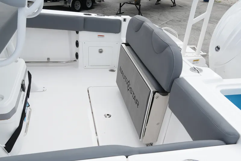 Slide: The Image of 2025 NauticStar 222 Offshore boat interior with gray seating and storage compartments. - 22