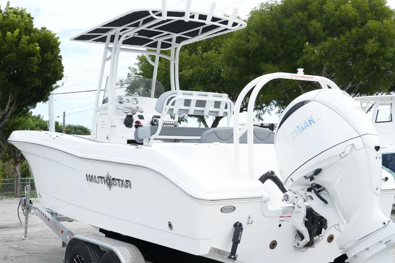 Slide: The Image of 2025 NauticStar 222 Offshore boat with Yamaha engine on trailer, side view. - 6