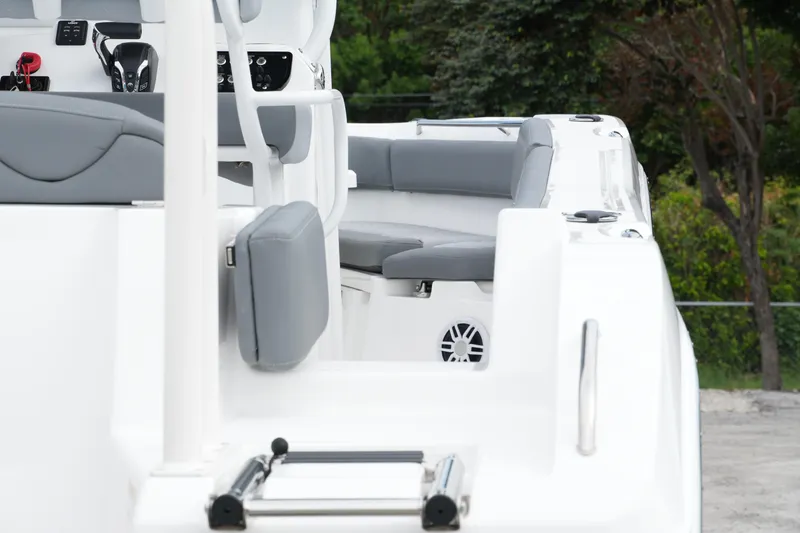 Slide: The Image of 2025 NauticStar 222 Offshore boat interior with gray seating and control panel. - 9
