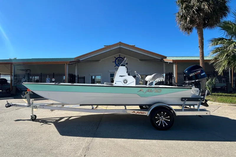 The Image of 2026 Avid 21 Recon ST boat on trailer, parked outside a building under clear blue sky. - 0