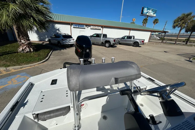 Slide: The Image of 2026 Avid 21 Recon ST boat parked near Everglades building, sunny day, palm trees. - 12