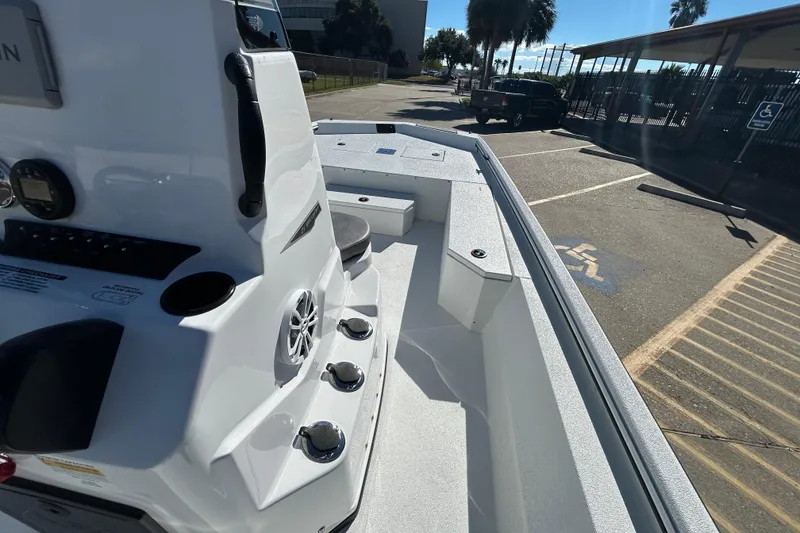 Slide: The Image of 2026 Avid 21 Recon ST boat interior, featuring console and seating in a parking lot setting. - 13