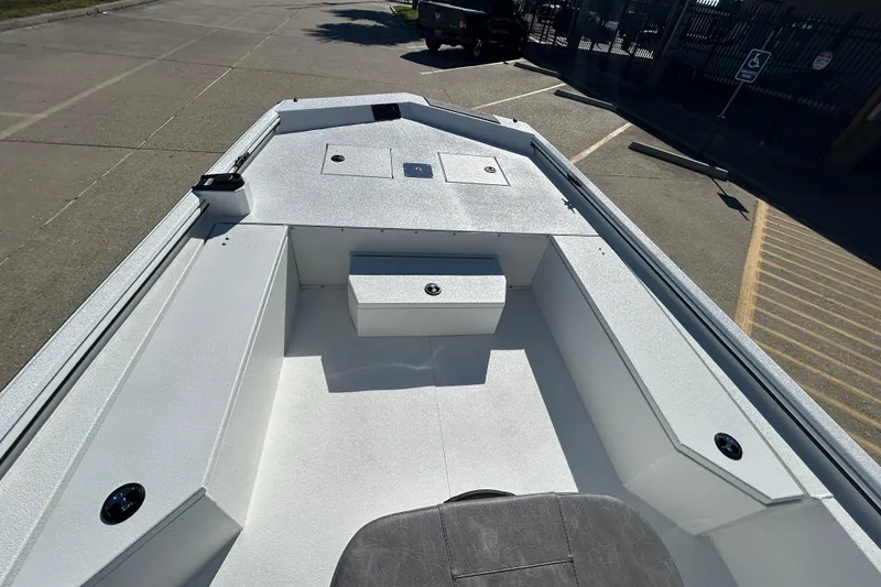Slide: The Image of 2026 Avid 21 Recon ST boat interior with storage compartments, parked on a concrete surface. - 15