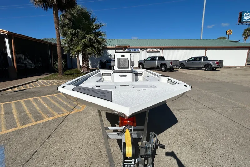 Slide: The Image of 2026 Avid 21 Recon ST boat on trailer in parking lot, sunny day. - 2