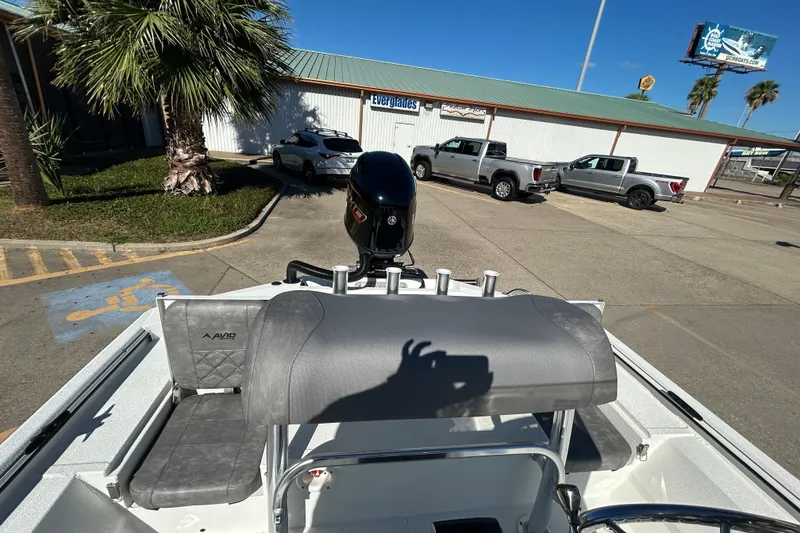 Slide: The Image of 2026 Avid 21 Recon ST boat parked near palm trees and vehicles. - 9