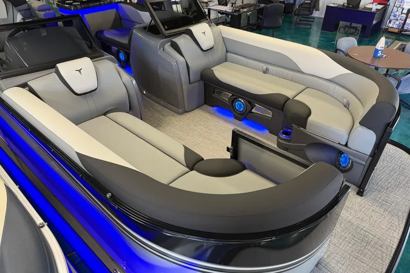 Slide: The Image of 2026 Tahoe Pontoon LTZ Elite Windshield interior with luxurious seating and ambient blue lighting. - 10