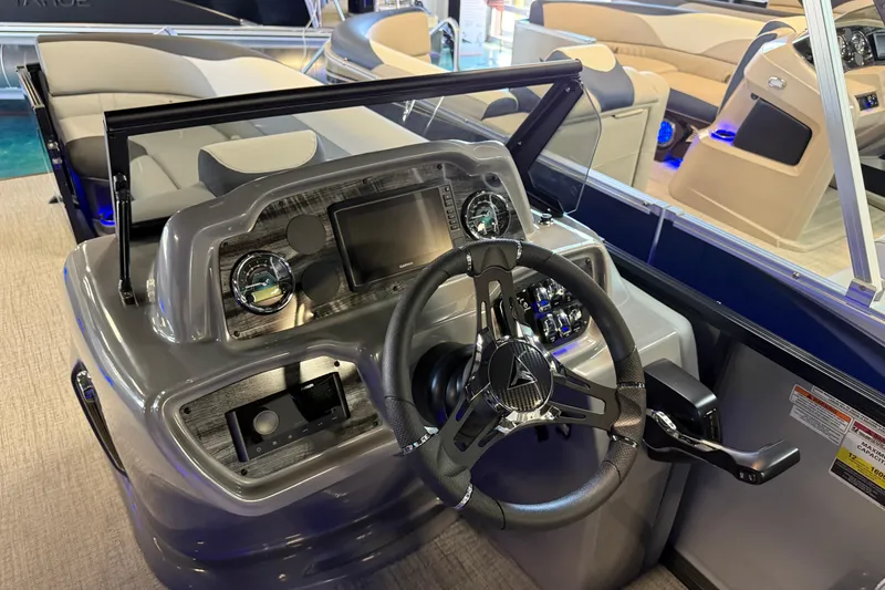 Slide: The Image of 2026 Tahoe Pontoon LTZ Elite Windshield dashboard with steering wheel and controls. - 6