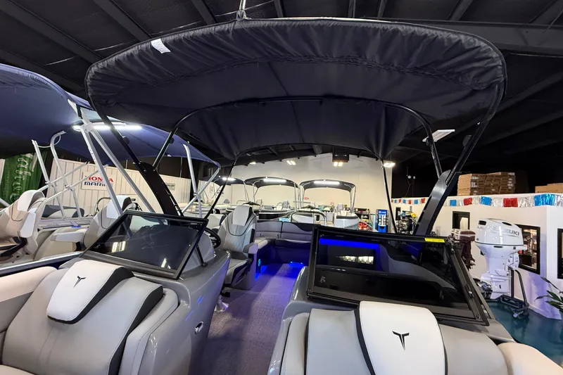 Slide: The Image of 2026 Tahoe Pontoon LTZ Elite Windshield boat with sleek design in showroom. - 8