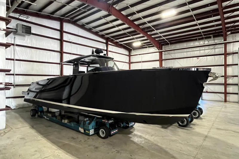 The Image of Black Alen 45 boat from 2018 in a spacious indoor storage facility. - 0