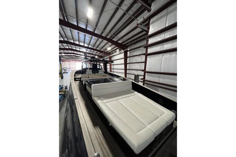 Slide: The Image of Luxurious 2018 Alen 45 yacht with white seating, docked in a spacious indoor facility. - 10