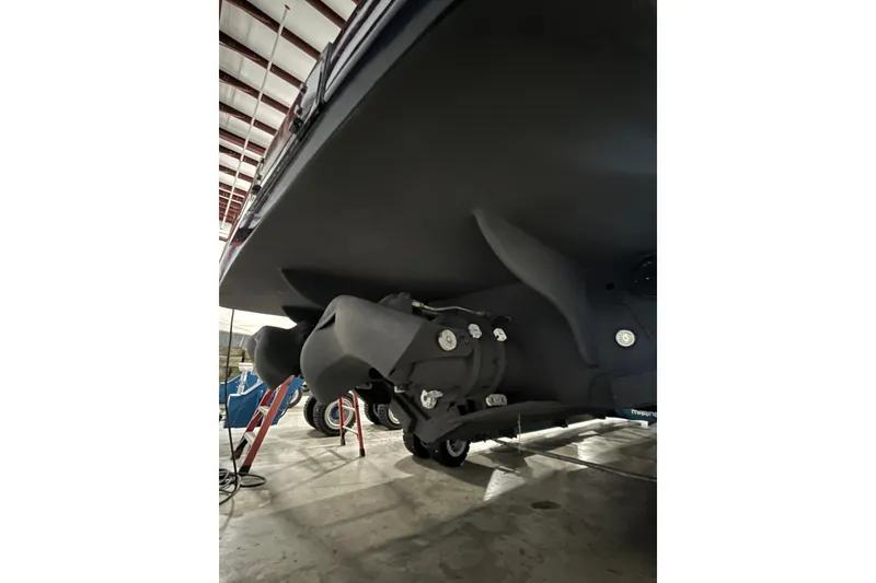 Slide: The Image of Underneath view of a 2018 Alen 45 boat in a storage facility. - 38
