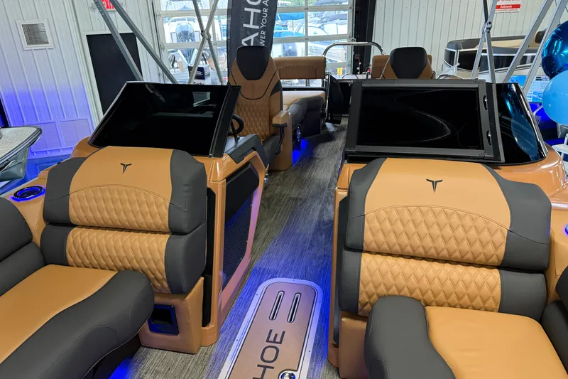 Slide: The Image of 2026 Tahoe Pontoon Cascade Quad Lounger interior with luxurious tan and black seating. - 5