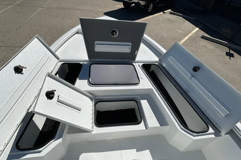 Slide: The Image of 2026 Avid 21 FST boat with open storage compartments on deck. - 15