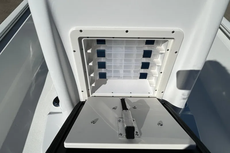 Slide: The Image of Avid 21 FST 2026 boat storage compartment with organized tackle boxes. - 18