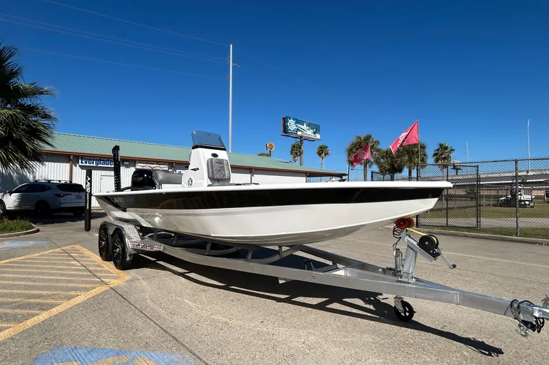 Slide: The Image of 2026 Avid 21 FST boat on trailer, parked outdoors under clear blue sky. - 3