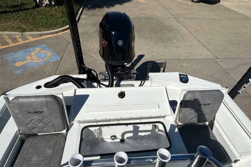 Slide: The Image of 2026 Avid 21 FST boat with Yamaha motor, featuring seating and storage compartments. - 9