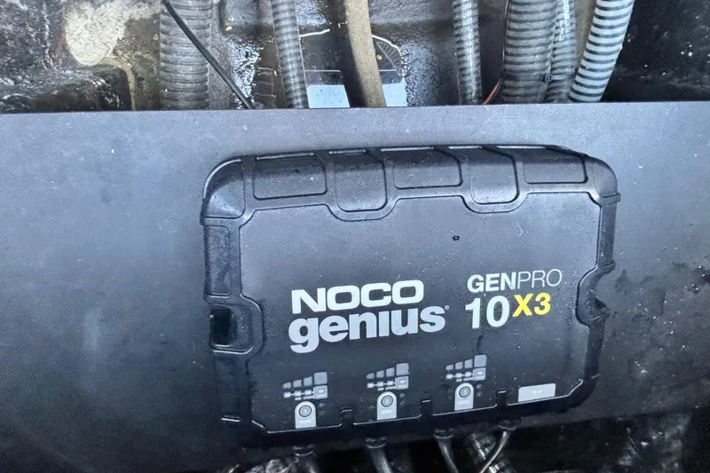 Slide: The Image of NOCO Genius GENPRO 10X3 charger in 2024 Triton 18 TrX boat. - 13