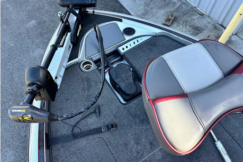 Slide: The Image of 2024 Triton 18 TrX boat deck with Minn Kota trolling motor and cushioned seat. - 3