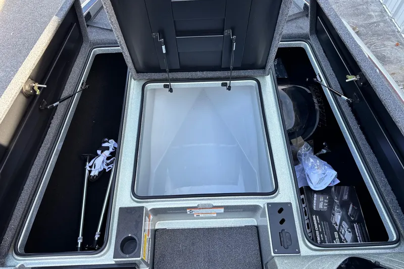 Slide: The Image of 2024 Triton 18 TrX boat storage compartments with open hatches and visible accessories. - 5