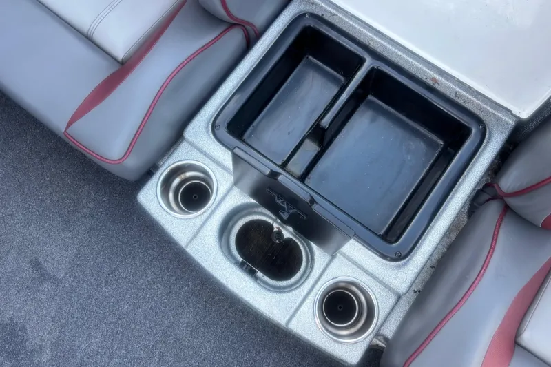 Slide: The Image of 2024 Triton 18 TrX boat interior with cup holders and storage compartments. - 9