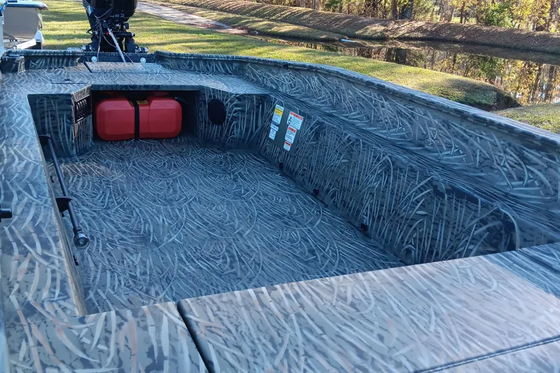 Slide: The Image of 2026 Tracker Grizzly 1650 T Prairie Wings Edition boat interior with camo design and red fuel tank. - 10