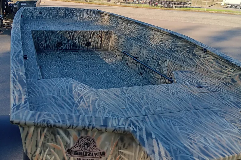 Slide: The Image of 2026 Tracker Grizzly 1650 T Prairie Wings Edition boat with camouflage design. - 11