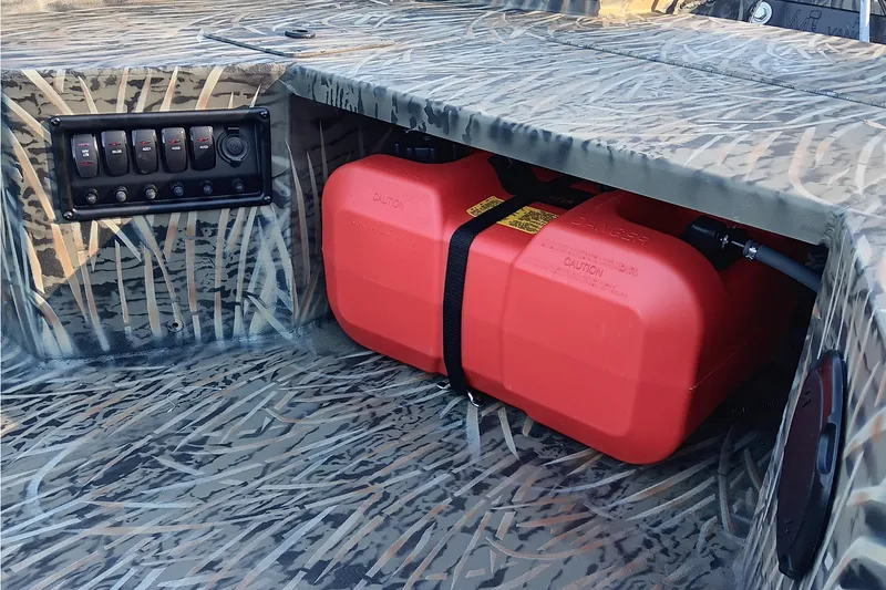 Slide: The Image of 2026 Tracker Grizzly 1650 T Prairie Wings Edition with camo design and red fuel tank. - 13