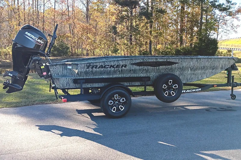 Slide: The Image of 2026 Tracker Grizzly 1650 T Prairie Wings Edition boat on trailer, parked outdoors. - 3