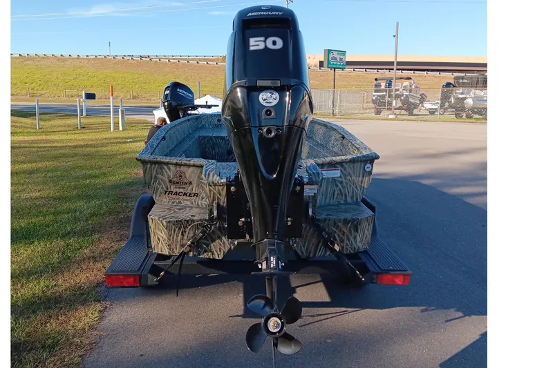 Slide: The Image of 2026 Tracker Grizzly 1650 T Prairie Wings Edition boat with Mercury 50 engine, parked outdoors. - 4