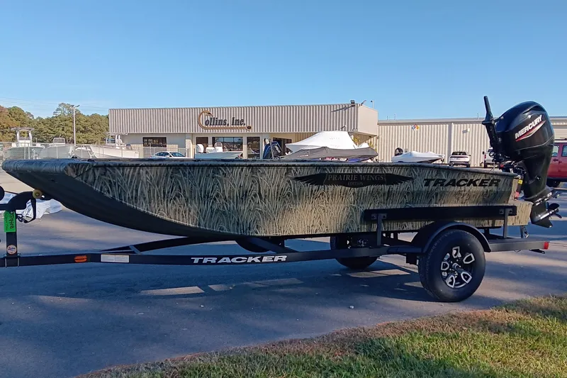 Slide: The Image of 2026 Tracker Grizzly 1650 T Prairie Wings Edition boat on trailer, outdoors. - 7