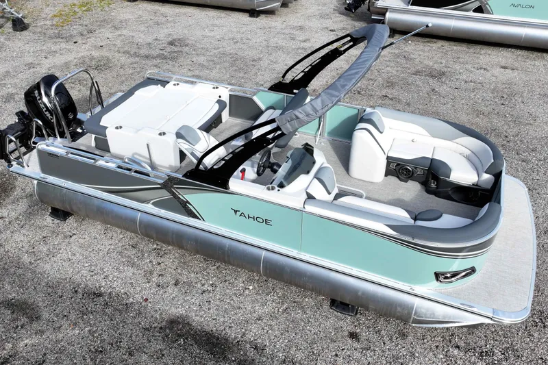 Slide: The Image of 2026 Tahoe Pontoon LTZ Entertainer with sleek design and spacious seating on gravel surface. - 9