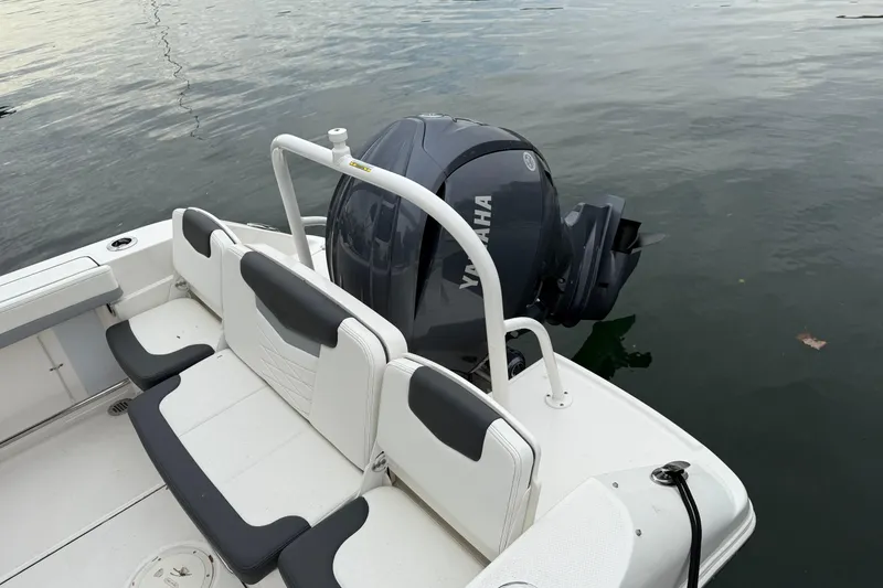 Slide: The Image of 2025 Robalo R207 Dual Console boat with Yamaha outboard motor on calm water. - 4