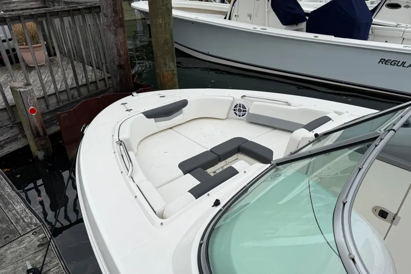 Slide: The Image of 2025 Robalo R207 Dual Console boat docked, featuring spacious seating and sleek design. - 6