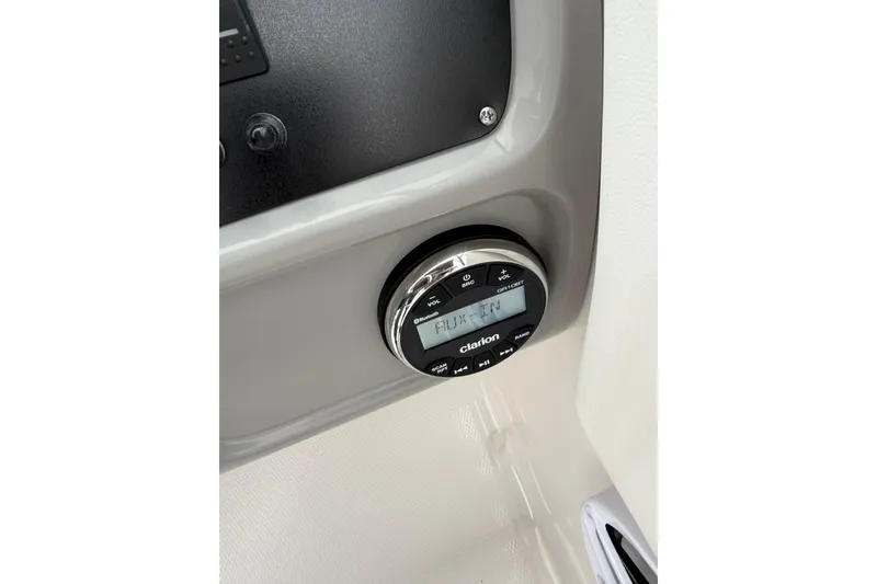 Slide: The Image of Clarion audio system in 2025 Robalo R207 Dual Console boat dashboard. - 9