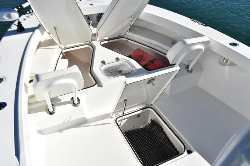 Slide: The Image of 2020 BlackJack 256 Coastal boat interior with open storage compartments and seating. - 10