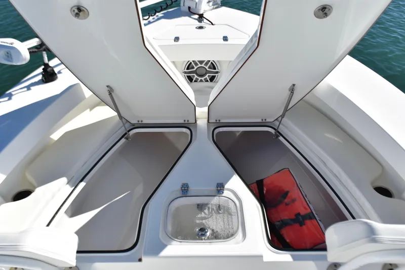 Slide: The Image of 2020 BlackJack 256 Coastal boat storage compartments open, showcasing spacious interior design. - 11